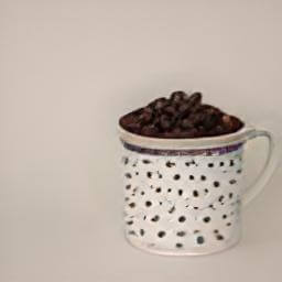 a cup filled with coffee beans