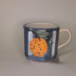 a blue and white striped cup orange illustration handle left 
                            used as a plant pot in studio