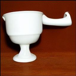 a plain white empty cup handle facing left in a studio