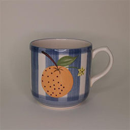 A cylindric cup with handle facing right 
                            A blue and white striped cup painted with an orange illustration 
                            An empty cup in studio
