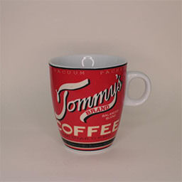 A small rounded cup with a handle facing right 
                            A red cup with a white vintage font writing and blue stripes 
                            An empty cup in studio