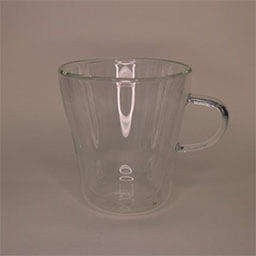 A double-walled cup with a handle facing right 
                            A translucent cup made of glass 
                            An empty cup in studio