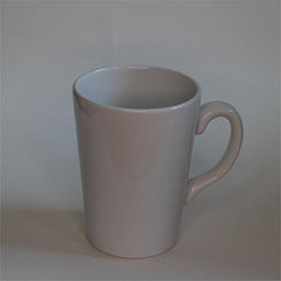A high cone shaped cup with a handle facing right 
                            A plain white cup 
                            An empty cup in studio