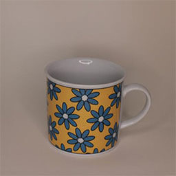 A small cylindric cup with a handle facing right 
                            A white cup with a yellow print with blue flowers 
                            An empty cup in studio
