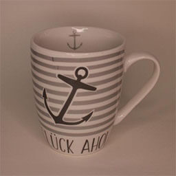 A high rounded cup with a handle facing right 
                            A white cup with beige striped and an anchor print and lettering 
                            An empty cup in studio
