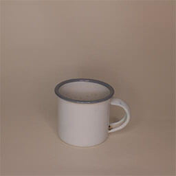 A tiny camping cup with a handle facing right 
                            A white cup with a blue rim 
                            An empty cup in studio