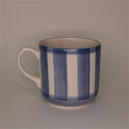 a cylindric cup with a handle facing left a blue and white striped cup an empty cup in studio