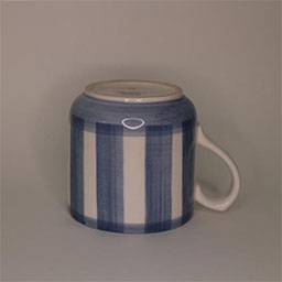 a cylindric cup turned upside down with a handle facing right a blue and white striped cup an empty cup in studio