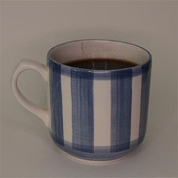 a cylindric cup with a handle facing left a blue and white striped cup 
                            a cup filled with coffee in studio