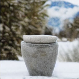 scandinavian stone glazed cup standing in front of a snow covered mountain natural muted colors chill landscape hipster